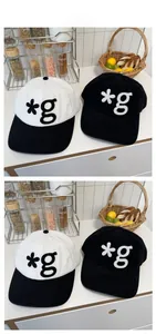 Detailed view of 3D star and letter g embroidery on cotton baseball caps