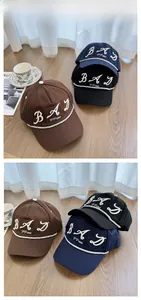 Detailed embroidery view of cotton baseball caps in brown, navy, and black colors