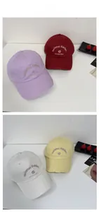 Detail showing vintage distressed baseball caps with rose floral embroidery in four colors
