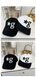 Detail of street style baseball caps featuring 3D letter embroidery and corduroy texture