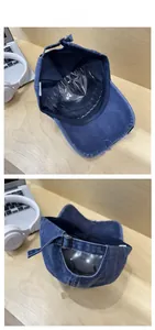 Detail of vintage denim baseball cap showing distressed brim and adjustable metal buckle