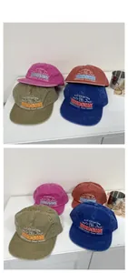 Detail of embroidered vintage washed cotton baseball caps in multiple retro colors