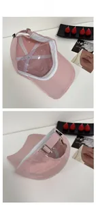 Detailed view of the pink cotton baseball cap featuring inner sweatband and metal buckle