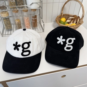 Two stylish baseball caps in black and white featuring embroidery and high-quality cotton fabric
