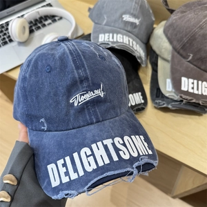 Distressed vintage washed blue baseball cap with white embroidery and wide brim