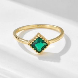 Detailed view of square emerald zircon on gold-plated ring with beaded bezel setting