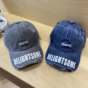 Vintage distressed baseball caps in gray and navy blue with white embroidery and lettering