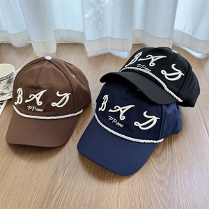Deep-fit baseball caps in brown, blue and black with embroidered letters and rope trim