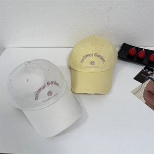 Retro distressed baseball cap with flower and letter embroidery in ivory and yellow
