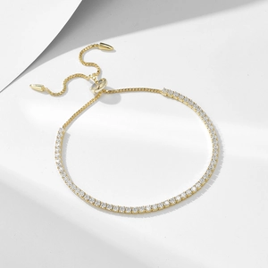 Adjustable S925 silver tennis bracelet with 2mm round zircons in a gold plated finish