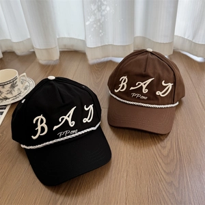 Streetwear style baseball caps in black and brown with 3D letter embroidery and cord detail