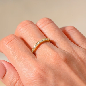 Minimalist gold ring with sparkling baguette and round pavé-set zircons on hand