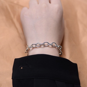 Close-up of a minimalist S925 sterling silver chain bracelet worn on a model's wrist