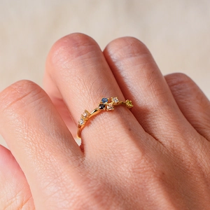 Minimalist S925 sterling silver ring with colorful zircons worn on model's finger
