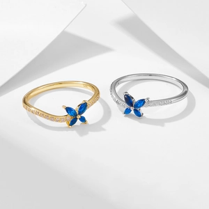 Silver and gold butterfly rings with blue crystals and zircon side accents