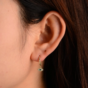 Detailed macro view of S925 silver evil eye hoop earring with blue zircon and gold plating