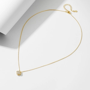 Macro shot of S925 hallmark on a gold clover necklace with sparkling zircon pavé
