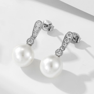 Detail of S925 sterling silver hallmark on elegant pearl earring with cubic zirconia