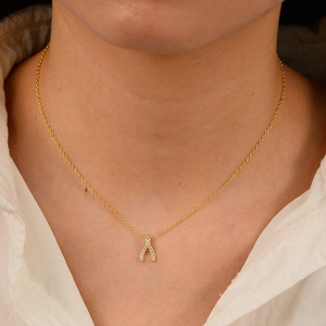 Elegant 18K gold plated S925 silver wishbone necklace with pavé zircon stones on a model