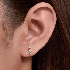 Vertical S925 silver bar earrings with five colorful zircons worn on earlobe