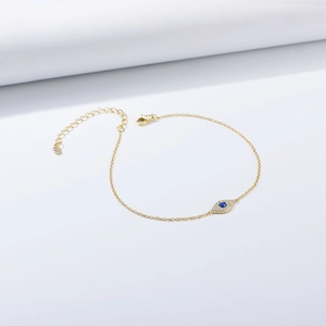 Detailed close-up of golden Evil Eye bracelet with blue zircon and adjustable chain