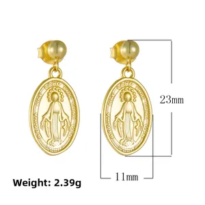 Close-up of golden Virgin Mary oval relief earrings with vintage religious engraving
