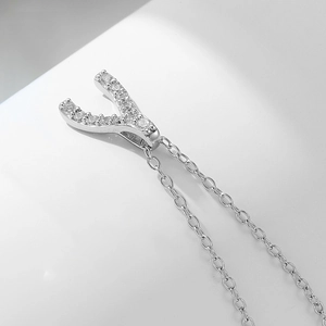 Detailed close-up of S925 sterling silver Y-shaped wishbone pendant with sparkling zircons