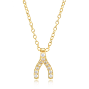 Macro detail of gold wishbone pendant with inlaid zircons on a delicate link chain