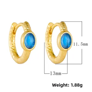 Detail of gold-plated hoop earrings with hammered texture and blue gemstone dimensions