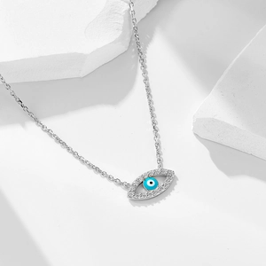 S925 sterling silver evil eye necklace with zircon stones on white geometric stand