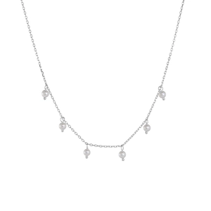 Detail of silver chain necklace featuring six elegant round white pearls spaced evenly
