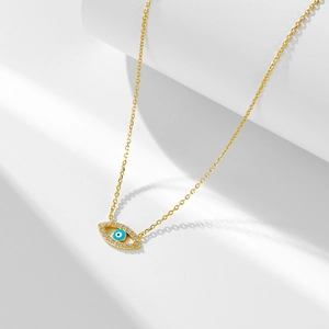 Macro view of gold S925 silver evil eye pendant with blue zircon micro-paving details