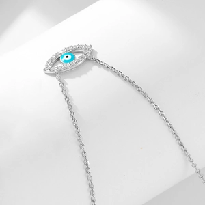 Macro shot of silver S925 Evil Eye pendant with micro-pave blue and white cubic zirconia