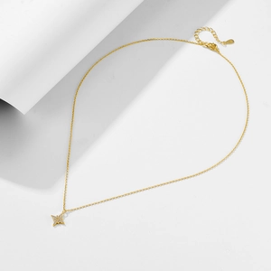 Detailed close-up of S925 sterling silver stamp on the gold-plated star necklace chain