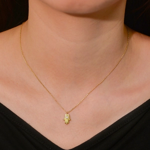 Elegant gold S925 silver Hamsa hand necklace with crystal pendant on female model