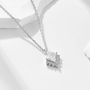 Minimalist 925 silver necklace with geometric rhombus zircon pendant on a white surface