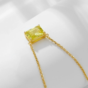 Macro shot of rectangular yellow zircon pendant set in gold-plated sterling silver