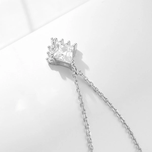 Close-up of geometric square zircon pendant with crown setting on silver chain