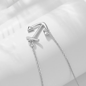 Close-up of polished silver anchor pendant on a fine O-chain with a minimalist design