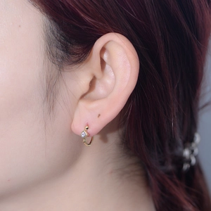 Classic gold S925 silver huggie earrings with square zircon stone worn by a model