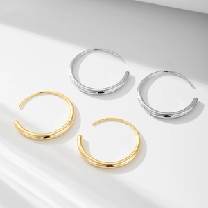 Minimalist geometric C-shaped hoop earrings in polished gold and silver finishes