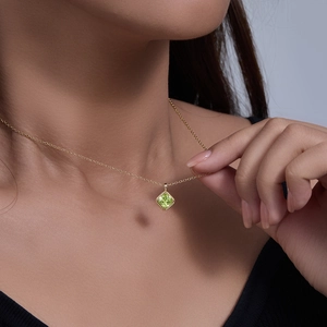 Detail of s925 silver necklace with emerald green square zircon pendant on model neck