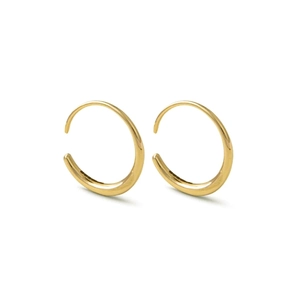 Detail of gold crescent-shaped thick hoop earrings with a high-polished metallic finish