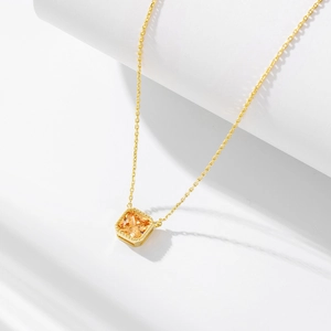 Macro detail of S925 silver champagne zircon pendant with gold beaded frame decoration