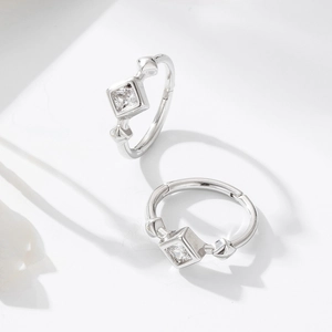 Close-up of S925 silver square zircon earrings with diamond-cut stud details