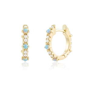 Macro view of gold hoop earrings with alternating blue opal and sparkling zircon stones