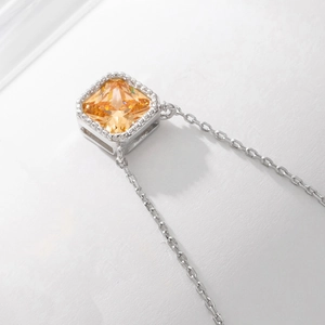 Macro detail of square champagne zircon pendant with beaded edge on S925 silver chain