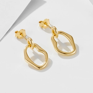 Detail shot of golden S925 sterling silver stamp on irregular geometric earrings