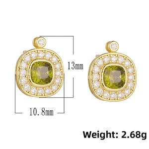 Detailed view of vintage gold stud earrings with olive green zircon and micro-pave crystals