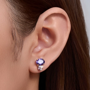 Elegant S925 silver studs with oval purple zircon stones and gold plating on model ear